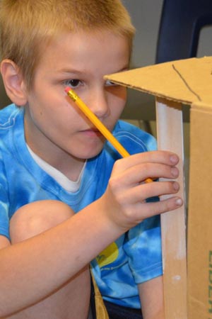 Boy measuring science project